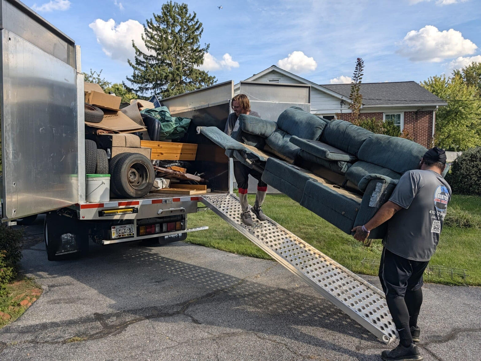 Junk removal truck loading furniture in Manor TX